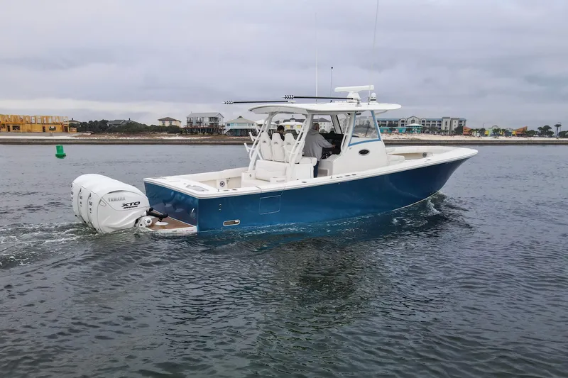 Slide: The Image of 2024 Regulator 37 boat cruising on water with Yamaha XTO engines. - 35