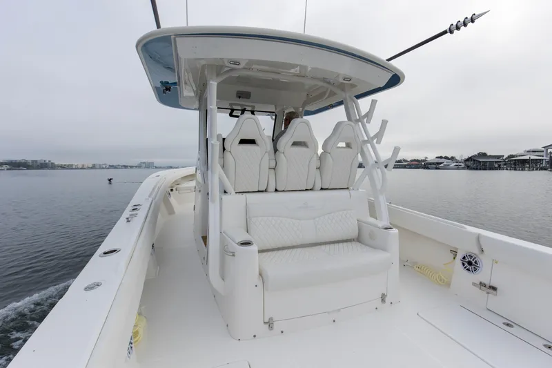 Slide: The Image of 2024 Regulator 37 boat interior with white seating, on calm water. - 4