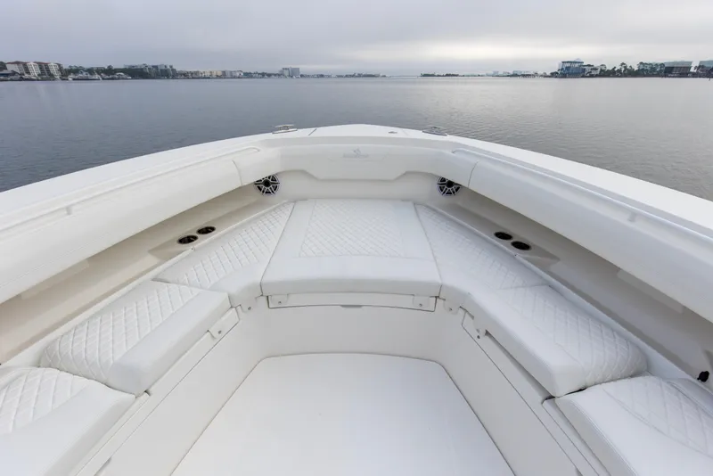 Slide: The Image of 2024 Regulator 37 boat interior with white cushioned seating and waterfront view. - 8