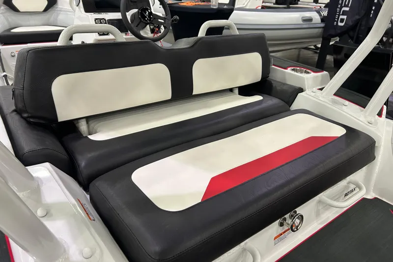 Slide: The Image of 2026 Highfield Velox 420 boat interior with black and white seating, steering wheel visible. - 7