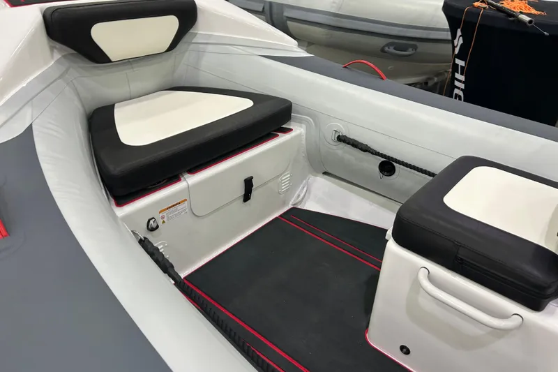 Slide: The Image of 2026 Highfield Velox 420 boat interior with cushioned seating and storage compartments. - 8