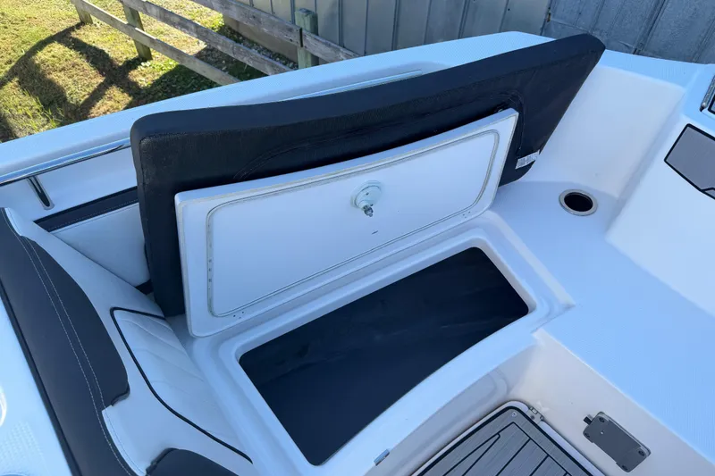Slide: The Image of 2022 Yamaha Boats 252 FSH Sport open storage compartment on deck. - 10