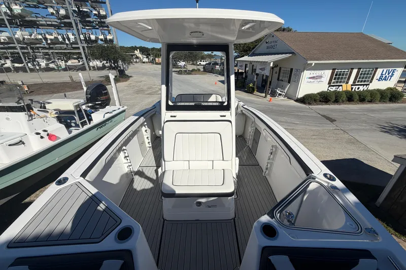 Slide: The Image of 2022 Yamaha Boats 252 FSH Sport, sleek interior design, docked at marina. - 11