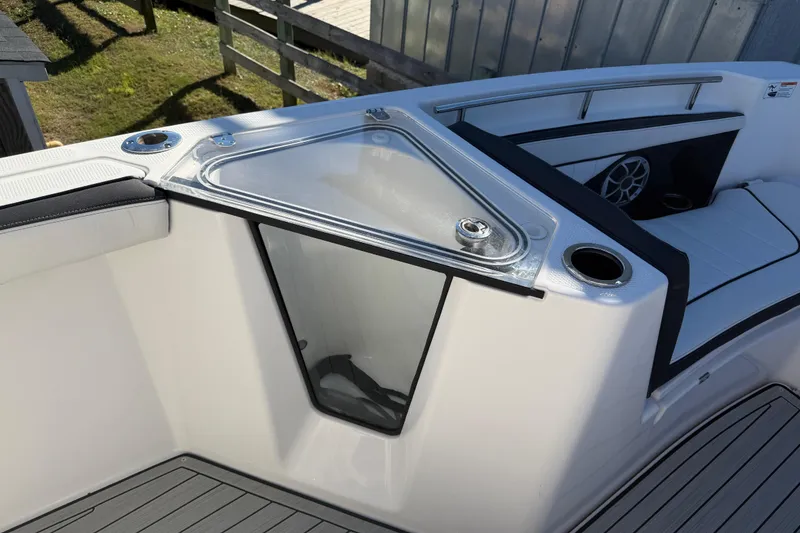 Slide: The Image of 2022 Yamaha Boats 252 FSH Sport interior with seating and storage compartment. - 12
