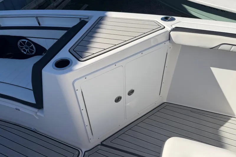 Slide: The Image of 2022 Yamaha Boats 252 FSH Sport interior with seating and storage compartments. - 13