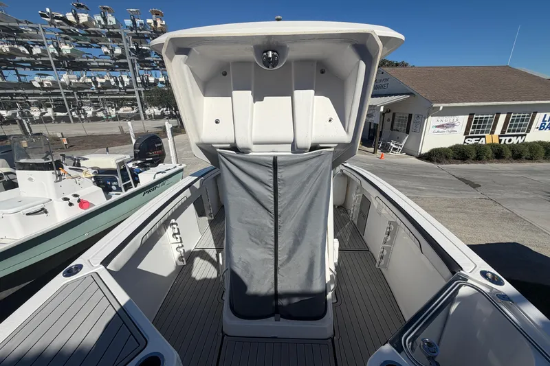 Slide: The Image of 2022 Yamaha Boats 252 FSH Sport interior view at marina, showcasing spacious deck layout. - 15