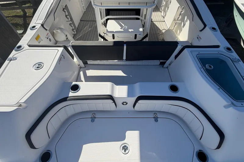 Slide: The Image of 2022 Yamaha Boats 252 FSH Sport interior with seating and storage compartments. - 32