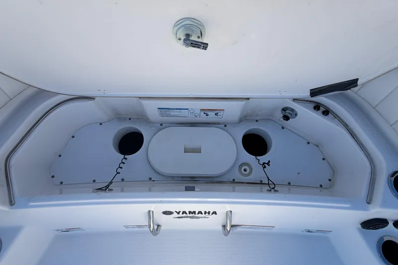 Slide: The Image of 2022 Yamaha Boats 252 FSH Sport storage compartment with cup holders and utility features. - 33
