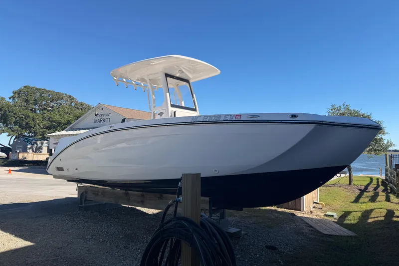Slide: The Image of 2022 Yamaha Boats 252 FSH Sport on display at a marina under clear blue skies. - 6