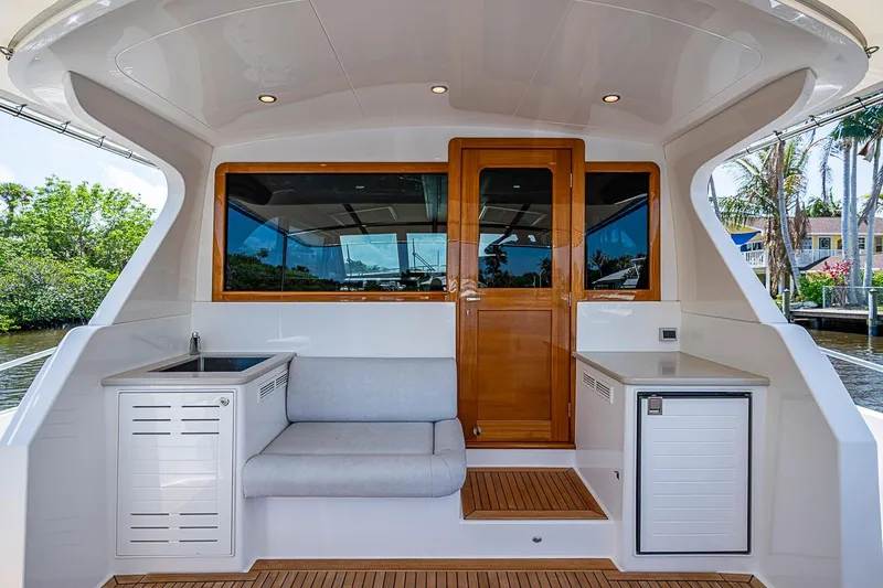 Slide: The Image of 2024 Grand Banks 44 Eastbay yacht interior with seating and wooden door. - 10