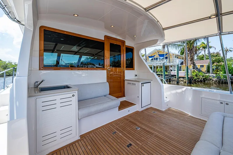 Slide: The Image of Luxurious 2024 Grand Banks 44 Eastbay yacht deck with seating and waterfront view. - 11