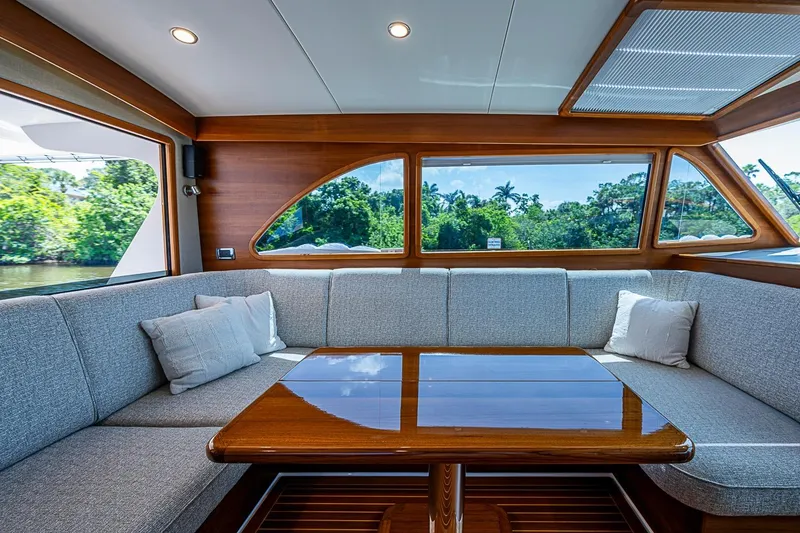 Slide: The Image of Luxurious interior of 2024 Grand Banks 44 Eastbay yacht with elegant seating and wooden table. - 19