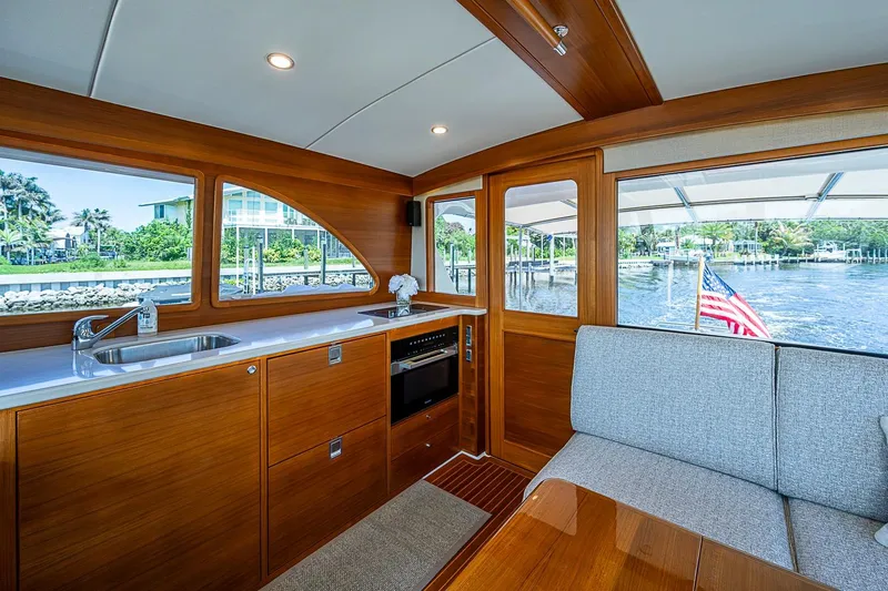 Slide: The Image of Interior of 2024 Grand Banks 44 Eastbay yacht with elegant wood finish and waterfront view. - 20