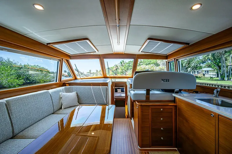 Slide: The Image of Luxurious 2024 Grand Banks 44 Eastbay yacht interior with elegant wood finish and spacious seating. - 21
