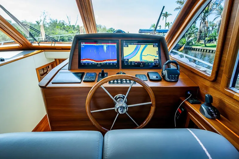 Slide: The Image of Helm of 2024 Grand Banks 44 Eastbay yacht with navigation screens and controls. - 24