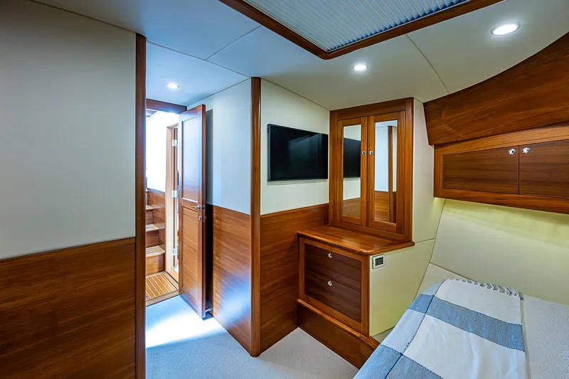 Slide: The Image of Luxurious cabin interior of 2024 Grand Banks 44 Eastbay yacht with wood accents. - 26