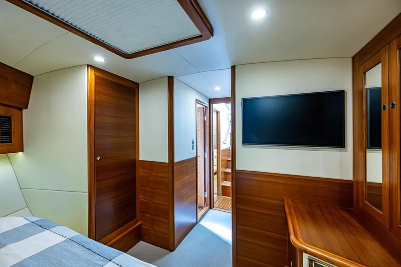 Slide: The Image of Luxurious interior of 2024 Grand Banks 44 Eastbay yacht with wood paneling and modern amenities. - 27