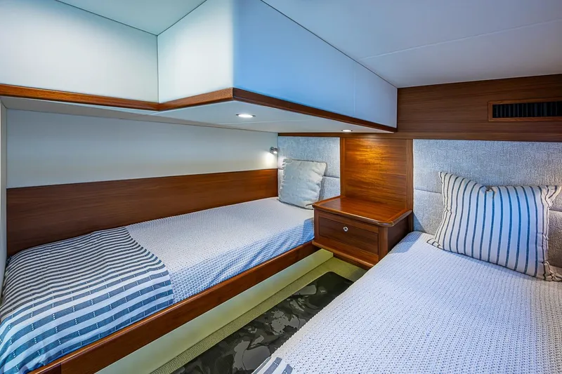 Slide: The Image of 2024 Grand Banks 44 Eastbay cabin with twin beds and elegant wood finish. - 31