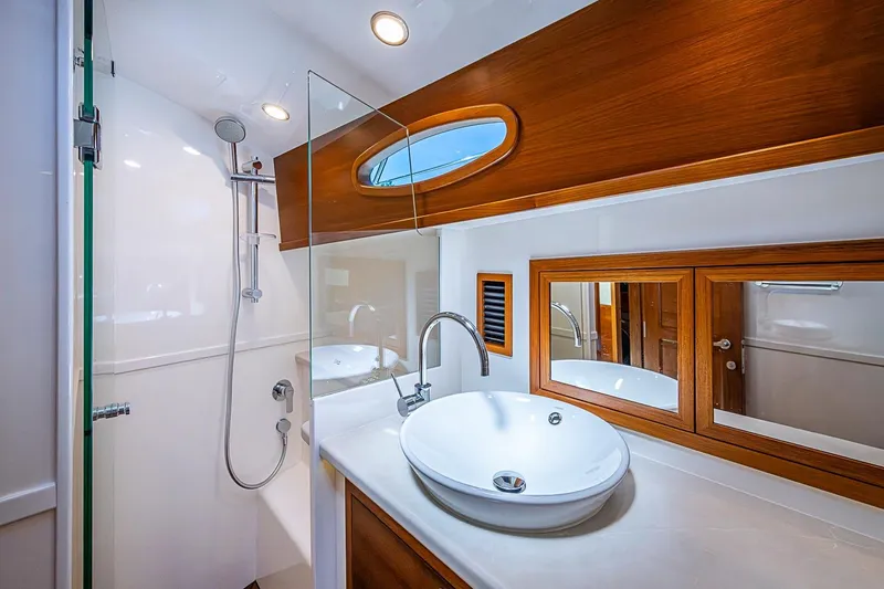 Slide: The Image of Luxurious bathroom in 2024 Grand Banks 44 Eastbay yacht with modern fixtures and wood accents. - 33