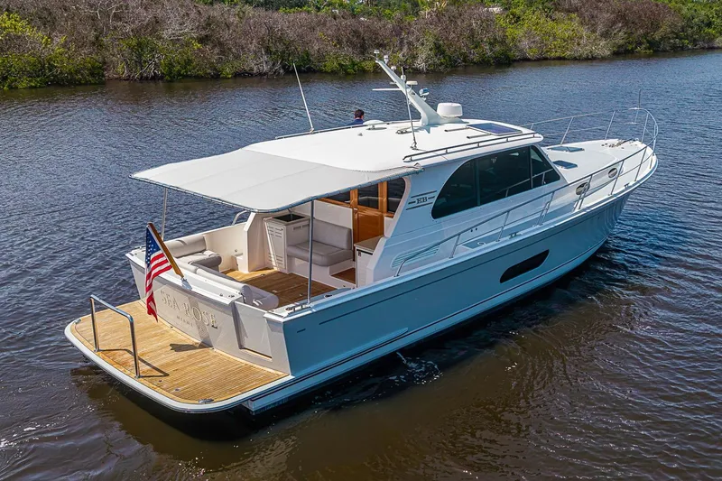 Slide: The Image of 2024 Grand Banks 44 Eastbay yacht cruising on a serene river. - 39
