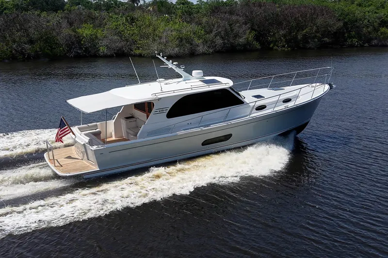 Slide: The Image of 2024 Grand Banks 44 Eastbay yacht cruising on a serene waterway. - 4