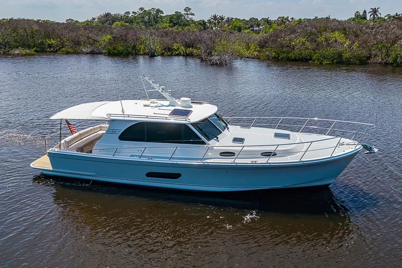 Slide: The Image of 2024 Grand Banks 44 Eastbay yacht cruising on a serene river. - 41