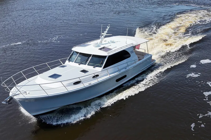Slide: The Image of 2024 Grand Banks 44 Eastbay cruising on open water, showcasing sleek design and performance. - 42