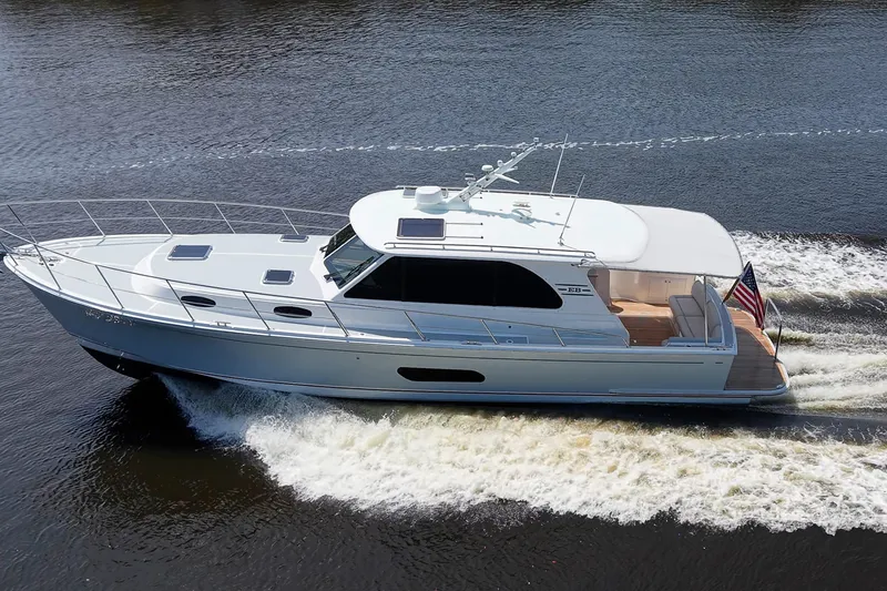 Slide: The Image of 2024 Grand Banks 44 Eastbay cruising on water, showcasing sleek design and performance. - 5