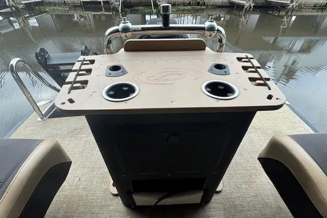 Slide: The Image of 2023 Barletta Cabrio 24CC boat helm with cup holders and control panel. - 16