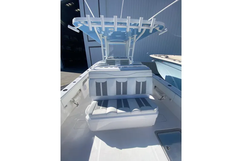 Slide: The Image of 2023 Invincible 33 Catamaran interior with cushioned seating and overhead rod holders. - 11