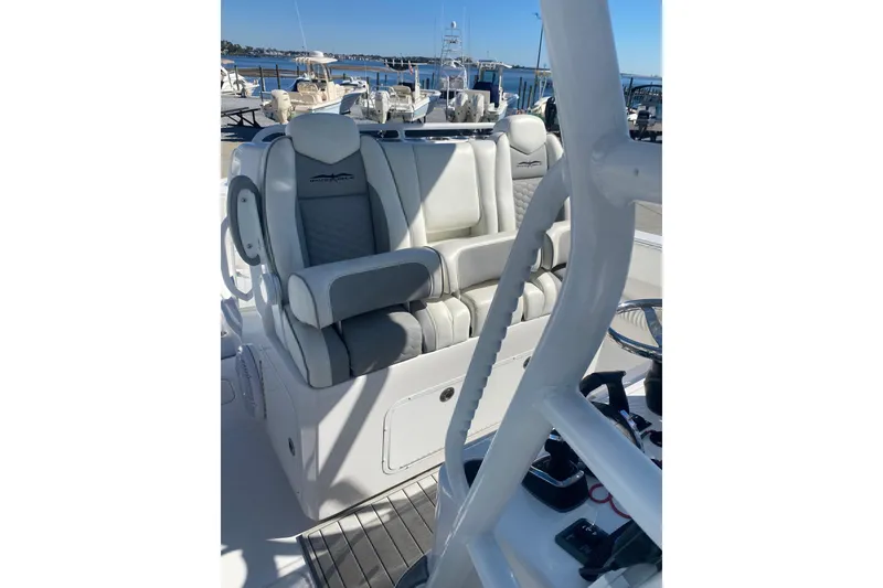 Slide: The Image of 2023 Invincible 33 Catamaran cockpit with luxurious seating and modern controls. - 15