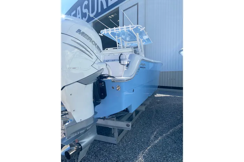 Slide: The Image of 2023 Invincible 33 Catamaran with Mercury engine, displayed outdoors. - 4