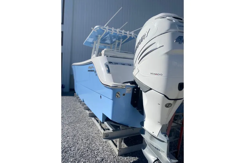 Slide: The Image of 2023 Invincible 33 Catamaran with Mercury Verado engine, displayed outdoors. - 5