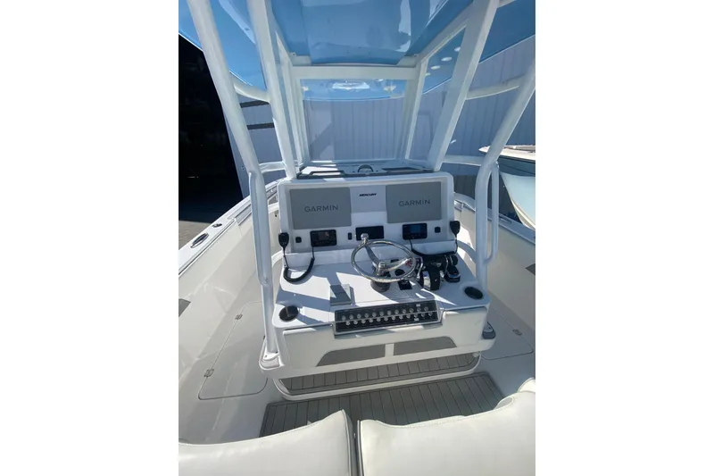 Slide: The Image of 2023 Invincible 33 Catamaran cockpit with Garmin navigation system and steering wheel. - 8