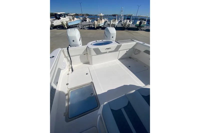 Slide: The Image of 2023 Invincible 33 Catamaran boat deck with twin engines, docked at marina. - 9