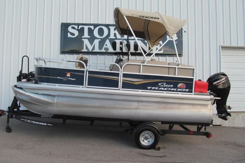 The Image of 2024 Sun Tracker Bass Buggy 16 XL Select pontoon boat with canopy and Mercury outboard motor. - 0