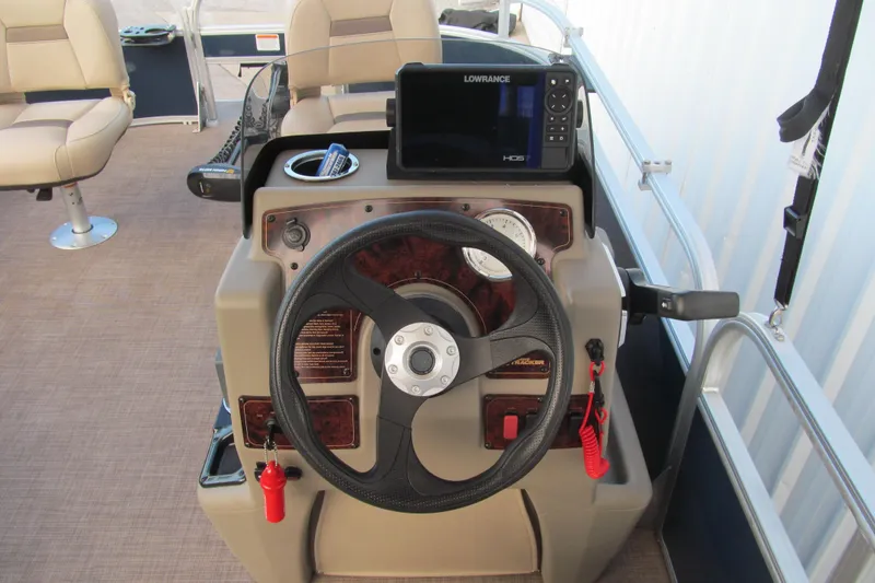 Slide: The Image of 2024 Sun Tracker Bass Buggy 16 XL Select dashboard with steering wheel and navigation system. - 6