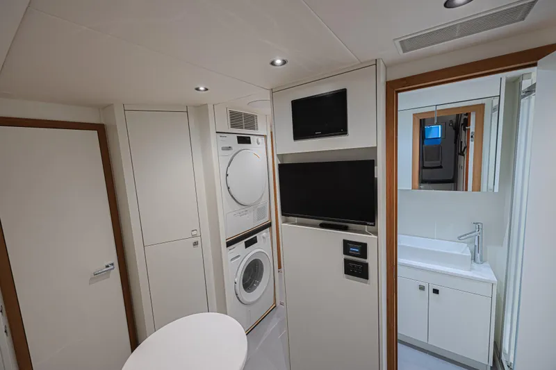 Slide: The Image of Laundry area and bathroom in 2025 Sunseeker 88 Yacht, featuring modern appliances and sleek design. - 12