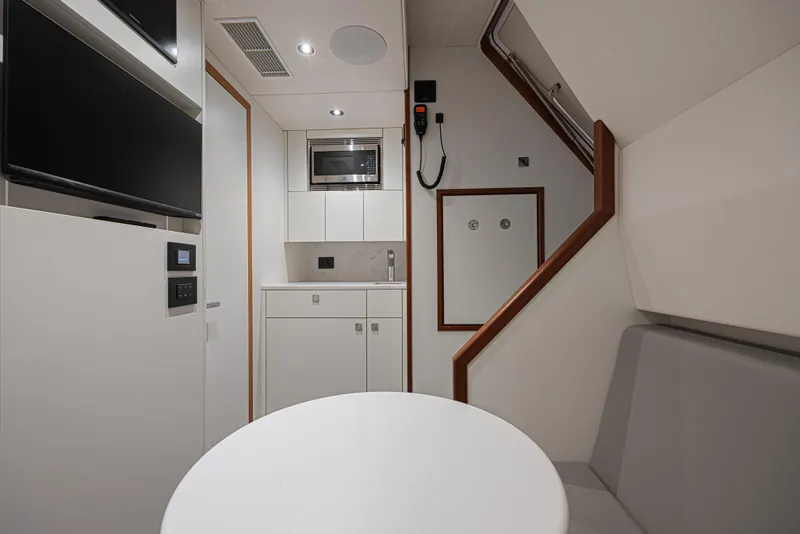 Slide: The Image of Modern interior of 2025 Sunseeker 88 Yacht featuring kitchenette and seating area. - 14