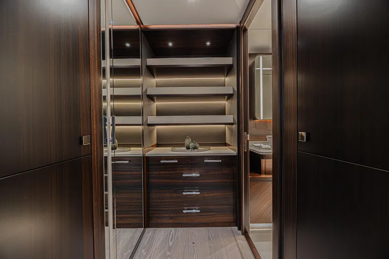Slide: The Image of Luxurious interior of 2025 Sunseeker 88 Yacht with elegant wood cabinetry and shelving. - 16