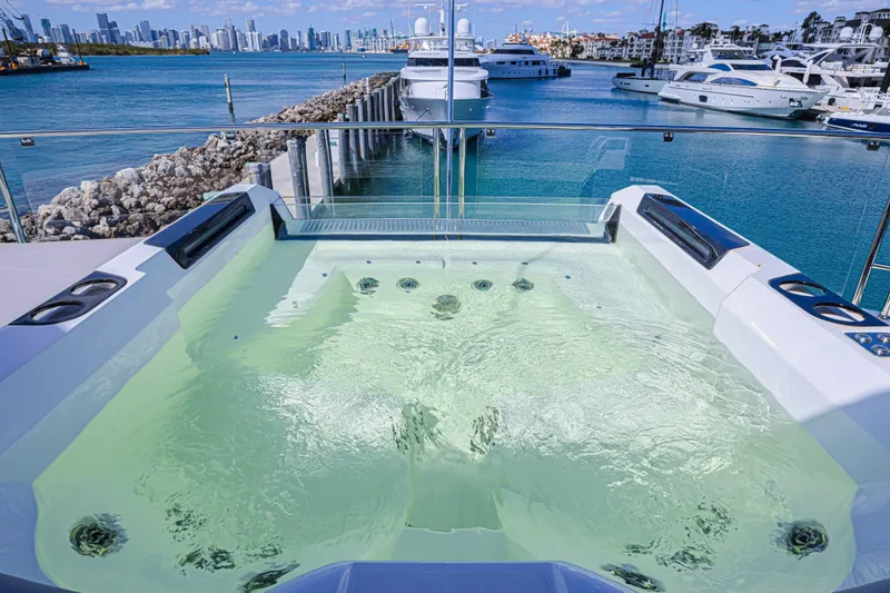 Slide: The Image of Luxurious Sunseeker 88 Yacht 2025 with jacuzzi, overlooking marina and city skyline. - 17