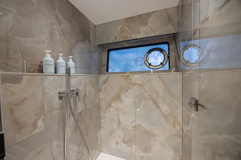 Slide: The Image of Luxurious bathroom in 2025 Sunseeker 88 Yacht with marble tiles and porthole window. - 33