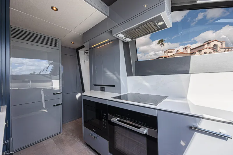 Slide: The Image of Modern kitchen interior of 2025 Sunseeker 88 Yacht with sleek appliances and scenic window view. - 43