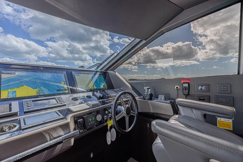 Slide: The Image of Interior view of 2025 Sunseeker 88 Yacht cockpit with navigation screens and steering wheel. - 46