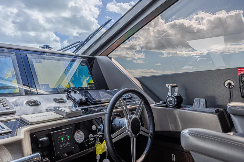 Slide: The Image of Cockpit of 2025 Sunseeker 88 Yacht with navigation screens and steering wheel. - 47