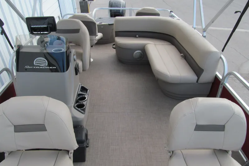Slide: The Image of 2023 Sun Tracker Bass Buggy 18 DLX pontoon boat interior with seating and console. - 10