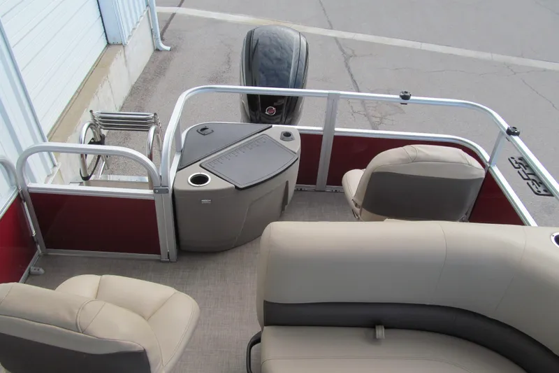 Slide: The Image of 2023 Sun Tracker Bass Buggy 18 DLX pontoon boat interior with seating and motor. - 13