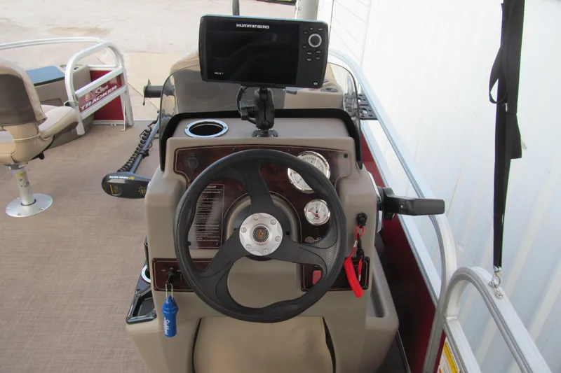 Slide: The Image of 2023 Sun Tracker Bass Buggy 18 DLX helm with steering wheel and Humminbird fish finder. - 5