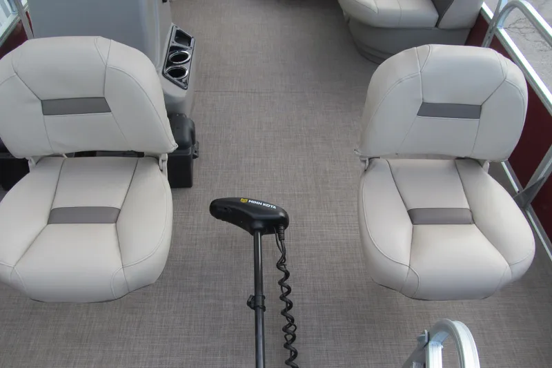 Slide: The Image of 2023 Sun Tracker Bass Buggy 18 DLX interior with two seats and Minn Kota trolling motor. - 9