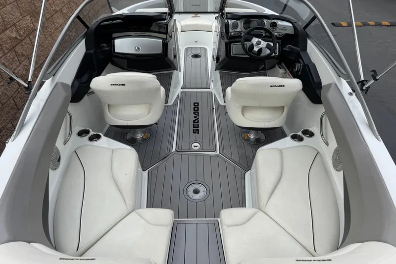 Slide: The Image of 2012 Bombardier Sea Doo 210 Challenger interior with white seating and modern dashboard. - 10